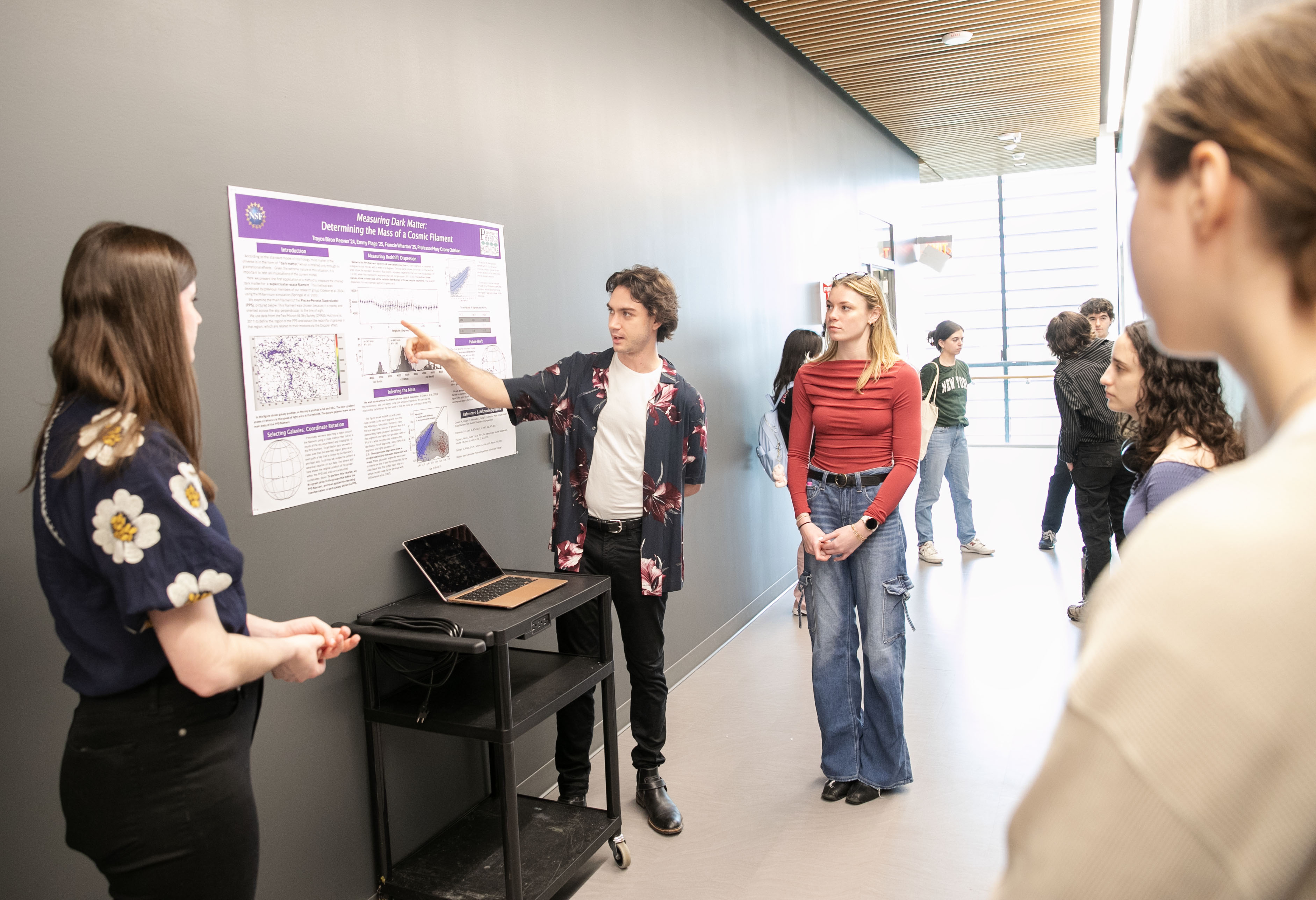 A poster presentation by physics major Trayce Reeves ’24, center, about measuring dark matter.