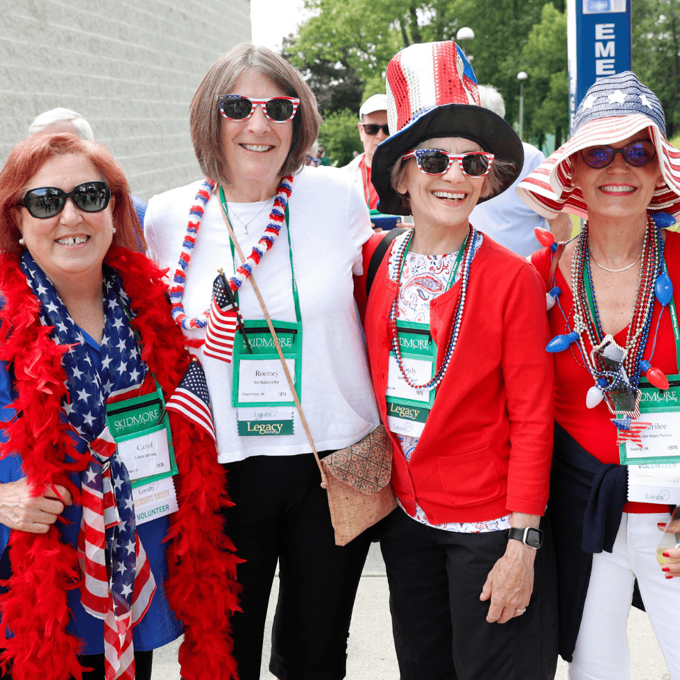 Members of the Legacy Society with classmates at reunion wearing festive American attire.