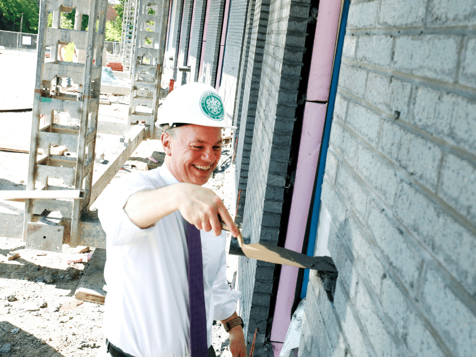 Skidmore College President Marc C. Conner lays the first ceremonial brick in the east wing of the Billie Tisch Center for Integrated Sciences.