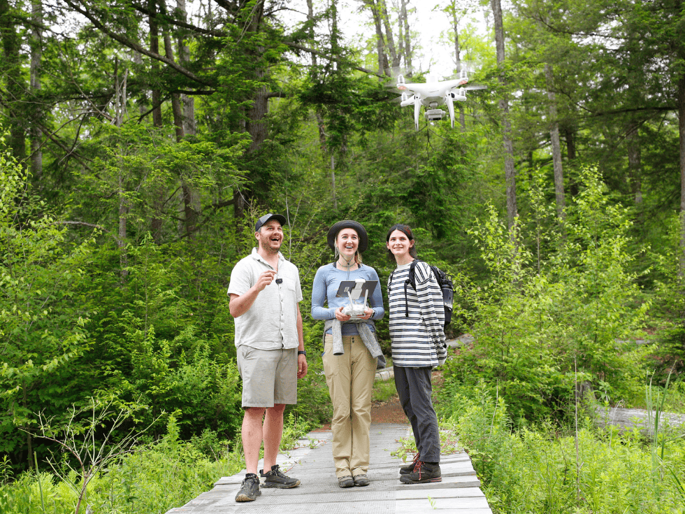 From left, Charlie Bettigole, director of the Skidmore GIS Center for Interdisciplinary Research, flies a drone with Skidmore College students Morgan Foster ’23 and Avery Blake ’23 Tuesday, June 21, 2022 to map the destruction of tress caused by the spongy moth caterpillars.