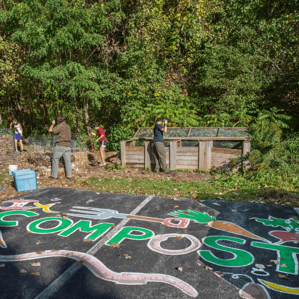 Skidmore College students volunteer at a campus composting work party.