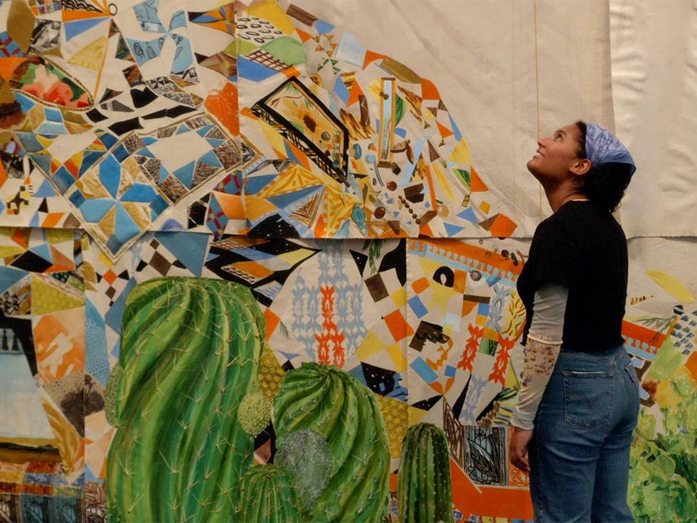 Olivia Berenson '24 looks at colorful artwork in the Tang Teaching Museum and Art Gallery