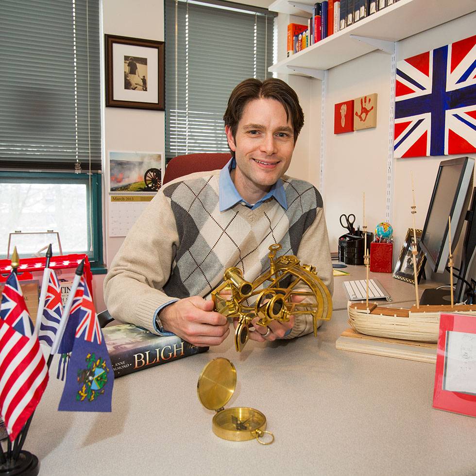 Tillman Nechtman in his office surround by various British artifacts and flags