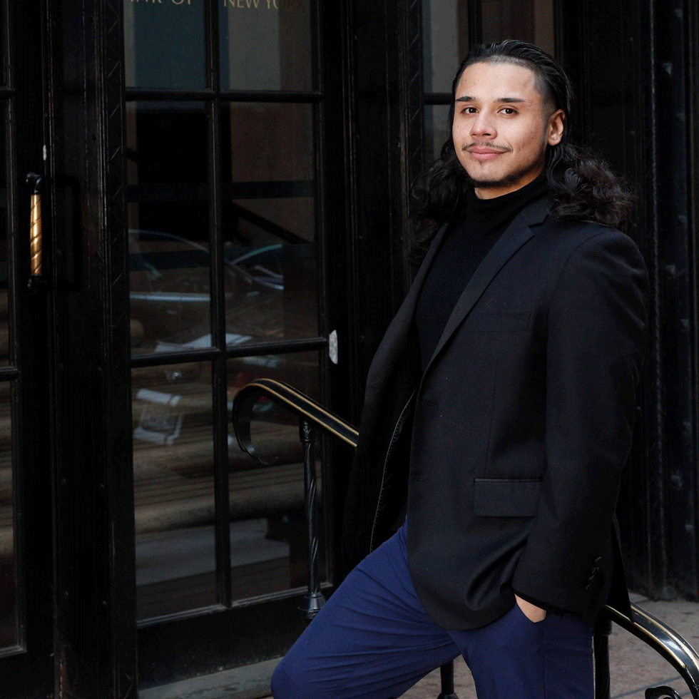 Edvin Leon Rios ’19 posing on stairs outside of the Federal Reserve Bank in New York City