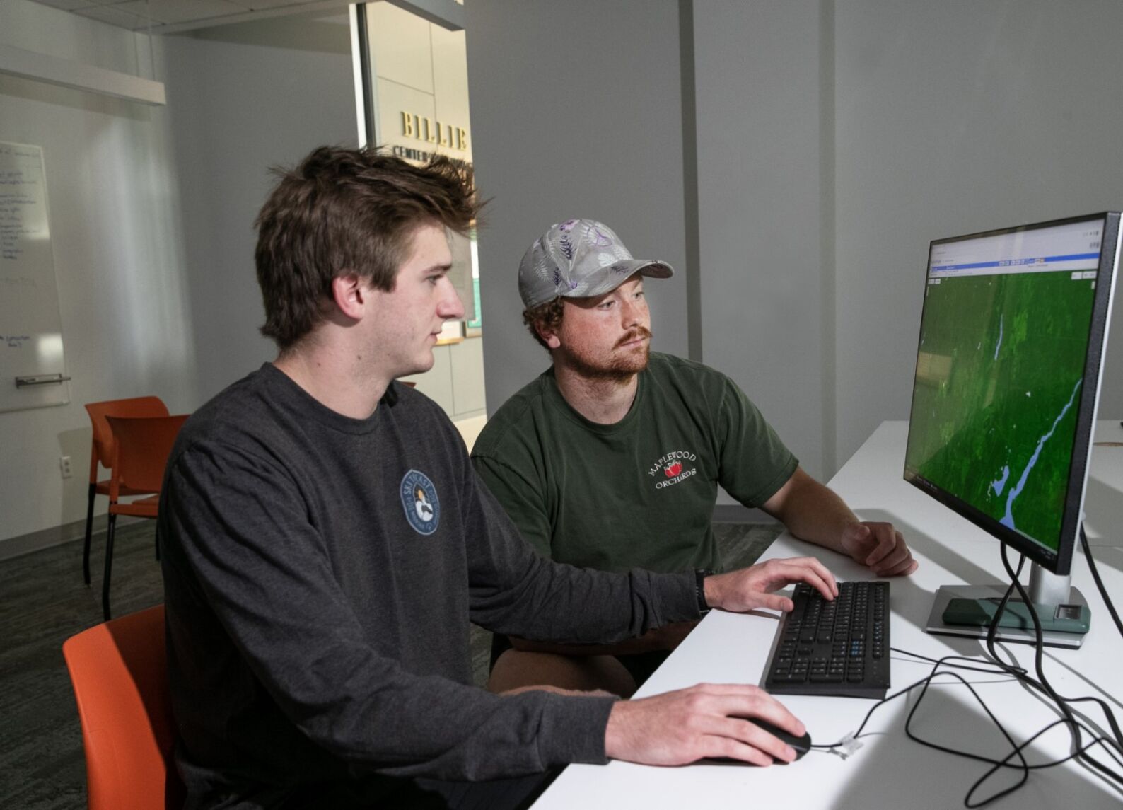 From left, Sam Haas '24 and Oliver Wilson '23 sit together looking at a computer in The Billie Tisch Center for Integrated Sciences.