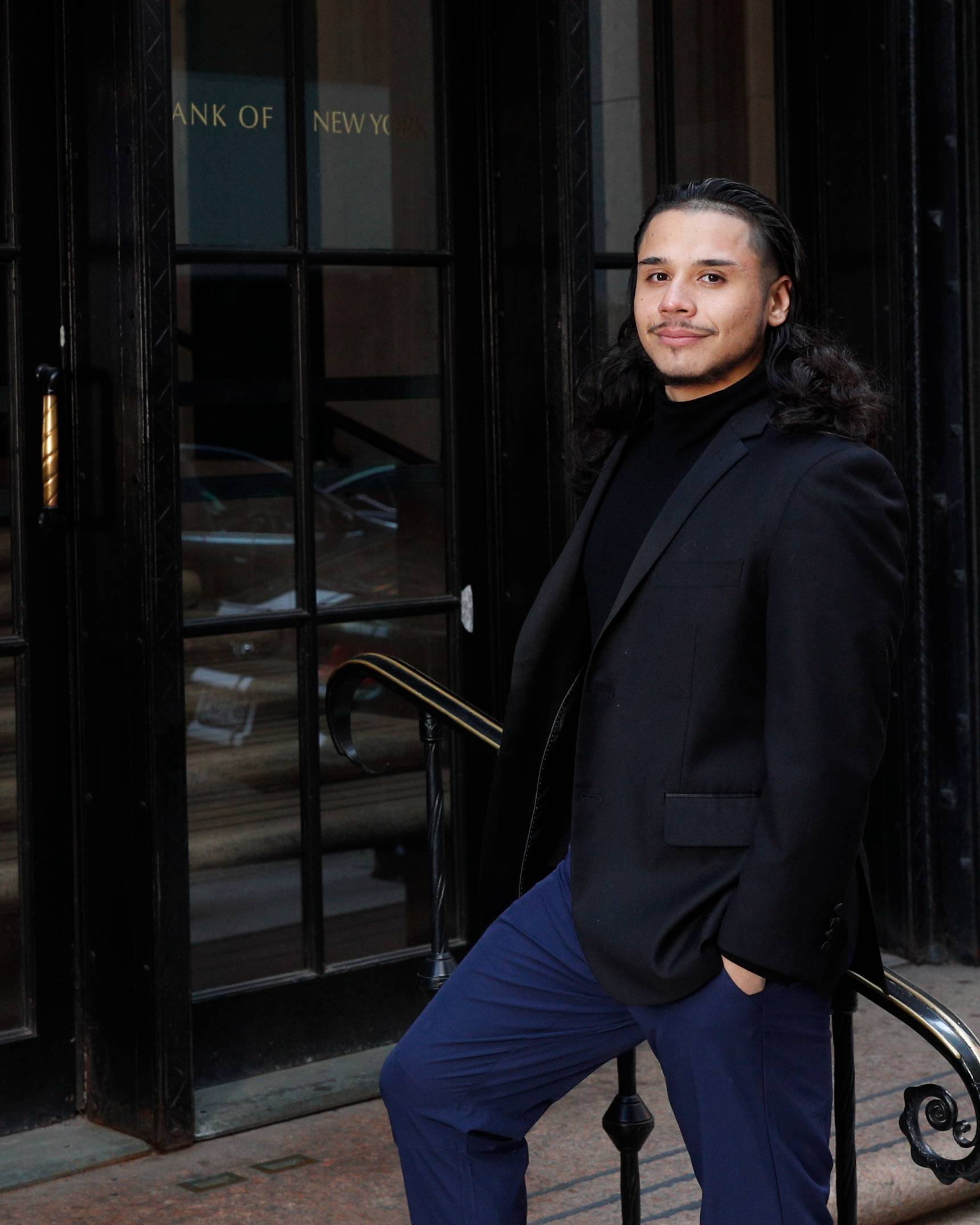 Edvin Leon Rios ’19 stands on the steps of the Federal Reserve Bank.