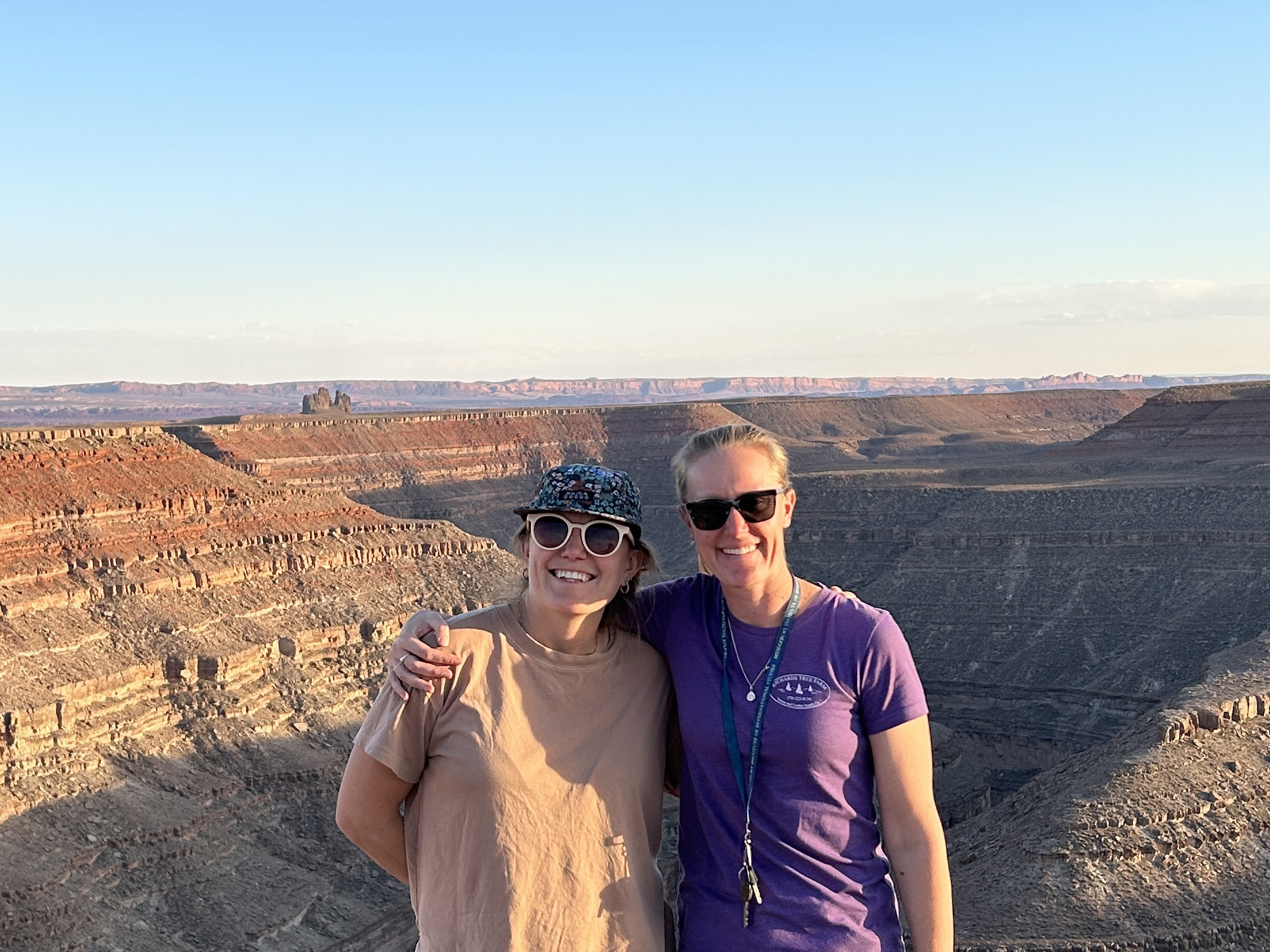 Anna Graves ’14 (left) and Danika Robison ’10 pose in front of a canyon at Goosenecks State Park in Utah.