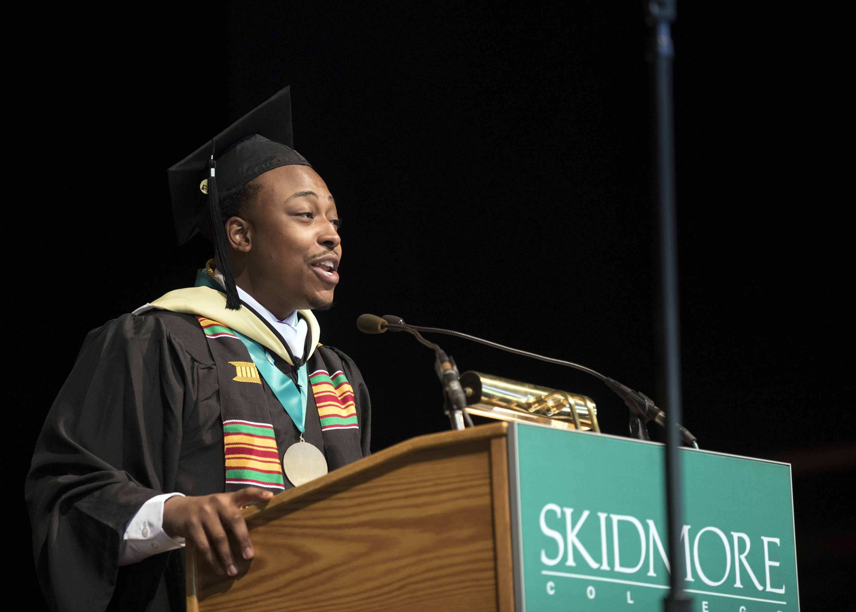 Nigel Smith ’19 stands at a podium at SPAC during Commencement for the Class of 2019