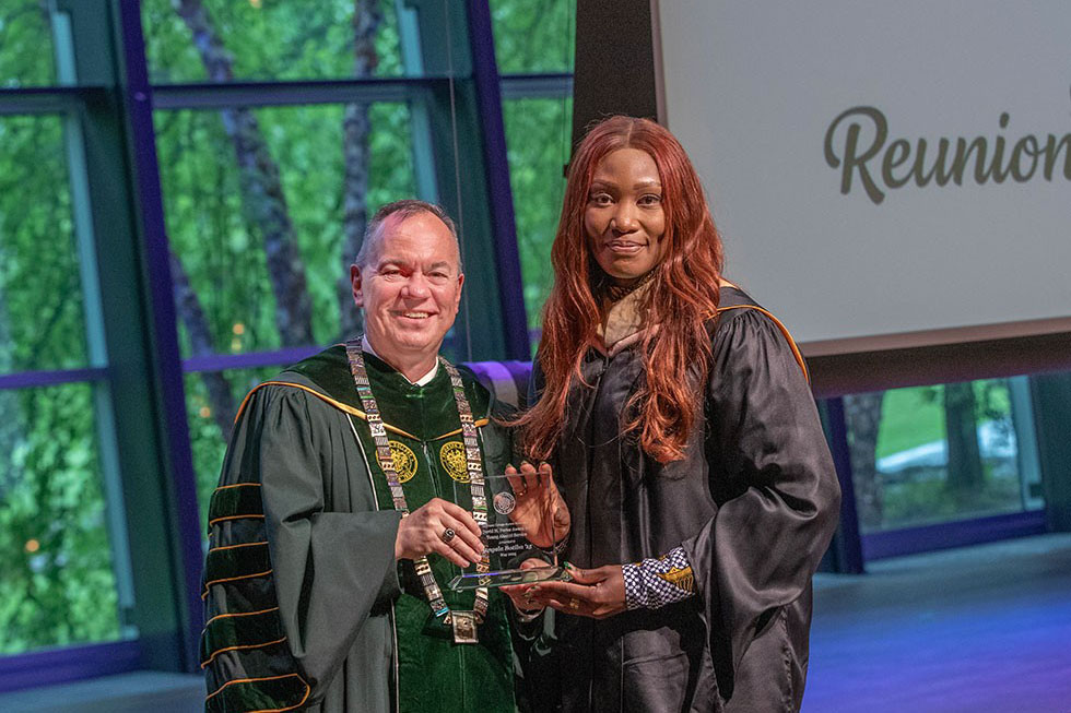 Angela Botiba '15 receives the David H. Porter Award for Young Alumni Service from College President Marc C. Conner.