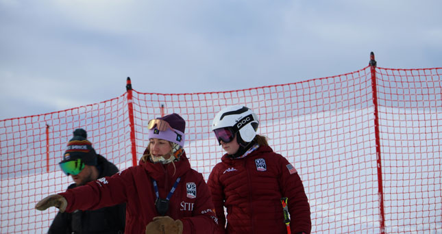 Lyndsay Strange ’09 coaches athletes on a snowy mountain slope.