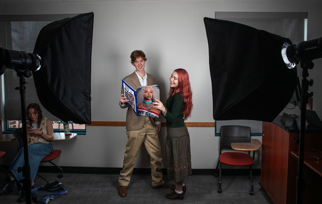 Wyatt Bancroft ’29 and Giulia Chiodi ’29 pose with a catalog of Beyoncé photos.