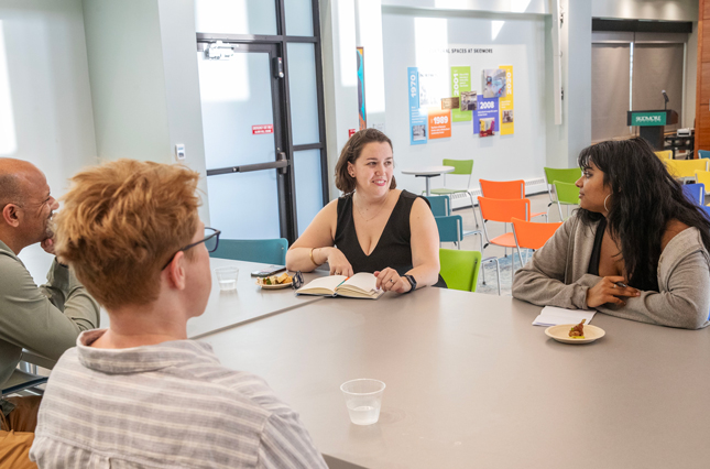 Sarah Faude '09, center, speaks with a student in Skidmore's Wyckoff Center. 