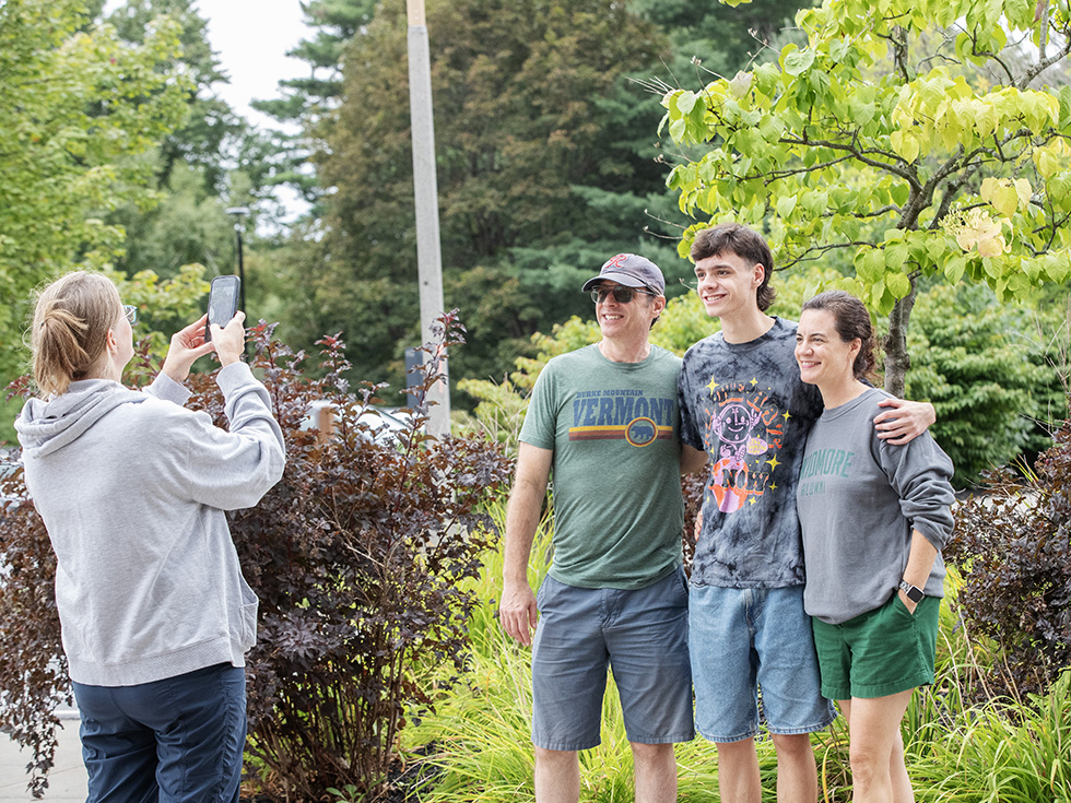 Somone taking at photo of a family during move-in