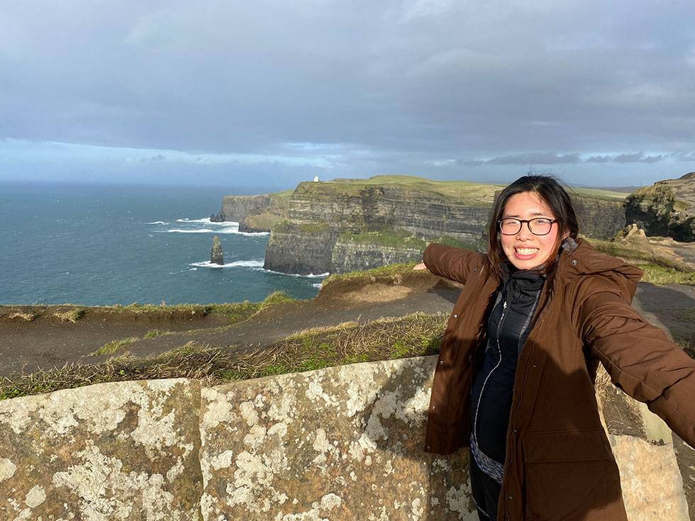 A student stands over the Cliffs of Moher in Ireland.