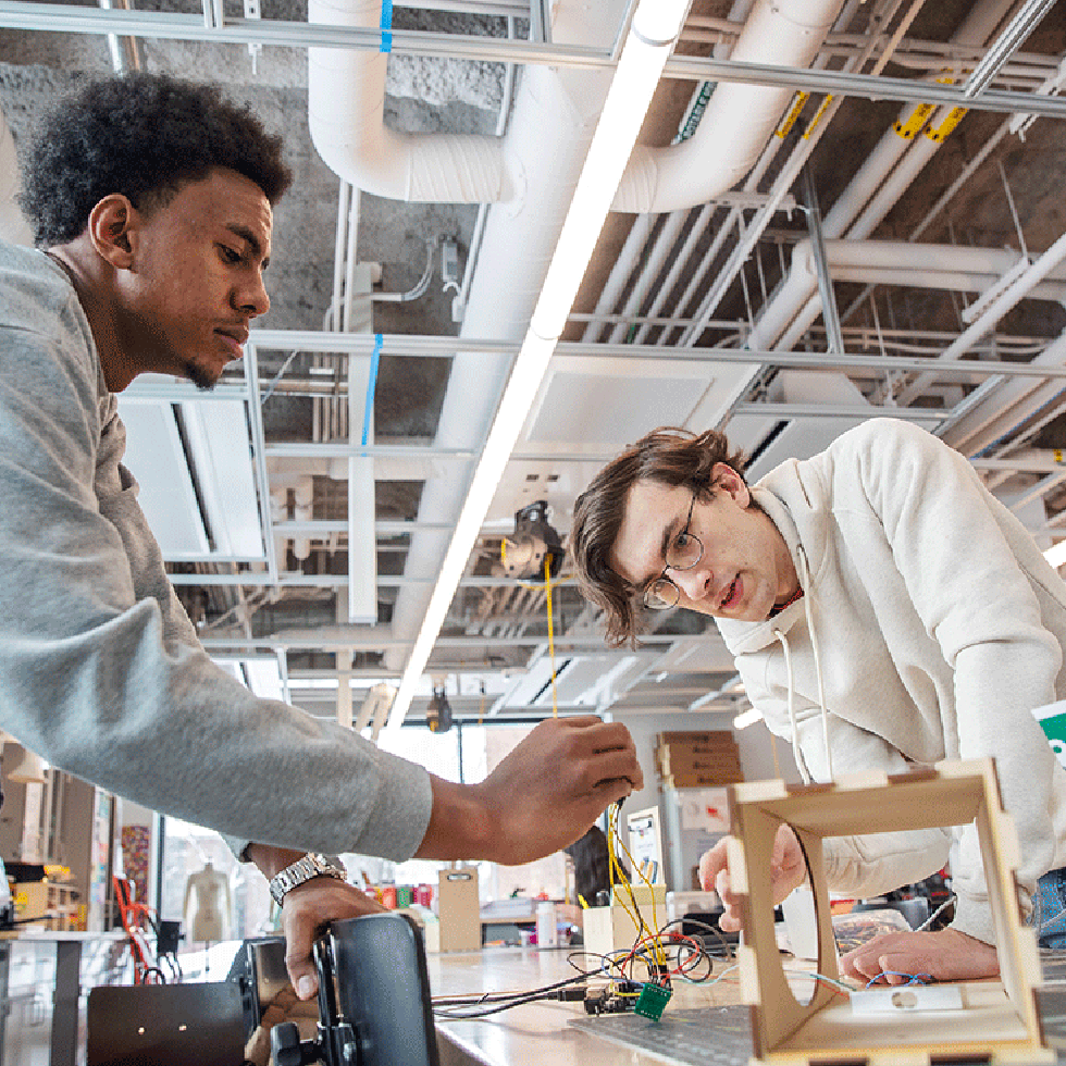 Two students work to build a prototype in Skidmore's IdeaLab