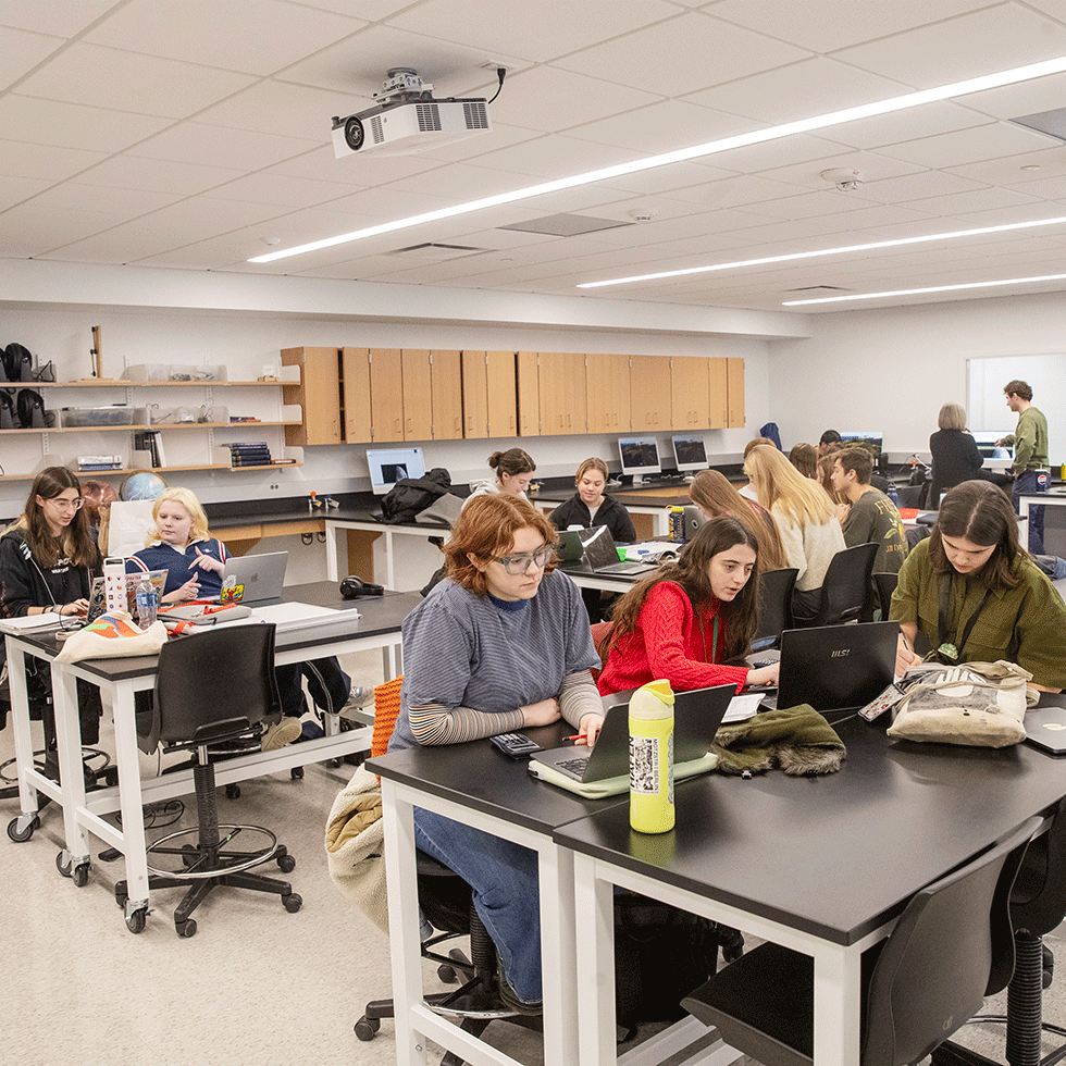 Students work at various tables in a Skidmore physics lab